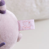 Close-up of the white and pink Pusheen Shop tag attached to the bottom of the plush.