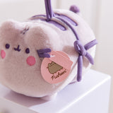 Close-up of the pink Pusheen Label logo tags attached near the face of the blushing cat toy plush.