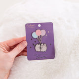 Model holding balloon pin backer card to show size and scale of deluxe pin.
