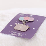 15th Anniversary Deluxe Pin shown at an angle to showcase the reflective outline of the dangling pin.