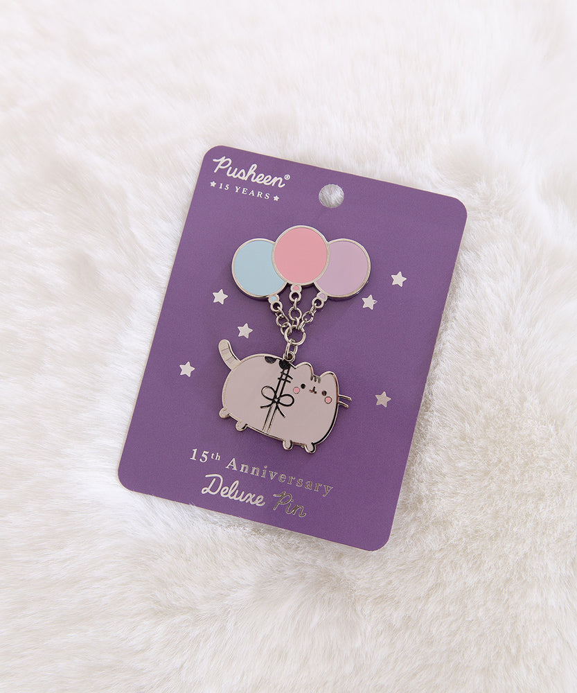 Pusheen 15th Anniversary Deluxe Pin on its purple and silver foil backer card. The backer card are foiled stars.