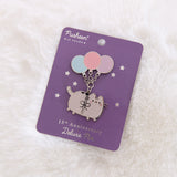 Pusheen 15th Anniversary Deluxe Pin on its purple and silver foil backer card. The backer card are foiled stars.