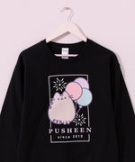 Black Pusheen Sweatshirt hangs on a hanger. The fair-themed crew neck sweatshirt is apart of the Pusheen's 15th Anniversary collection.