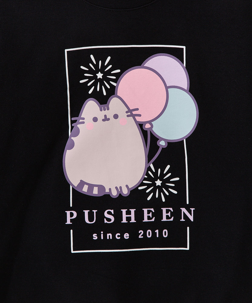 Close-up of the anniversary sweatshirt graphic. The large front graphic features a pastel gray Pusheen with the phrase "Pusheen Since 2010" below the graphic of the cat, fireworks, and balloons.