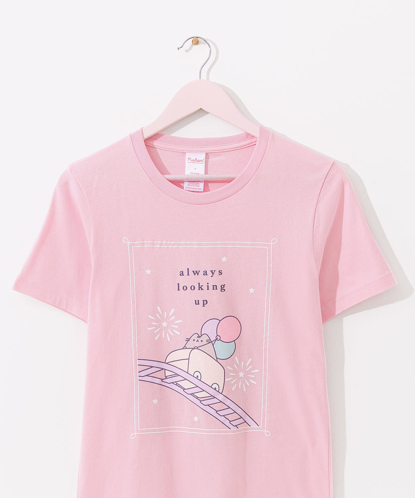 Light pink Pusheen tee hangs on a hanger. The fair-themed pink tee is apart of the Pusheen's 15th Anniversary collection.