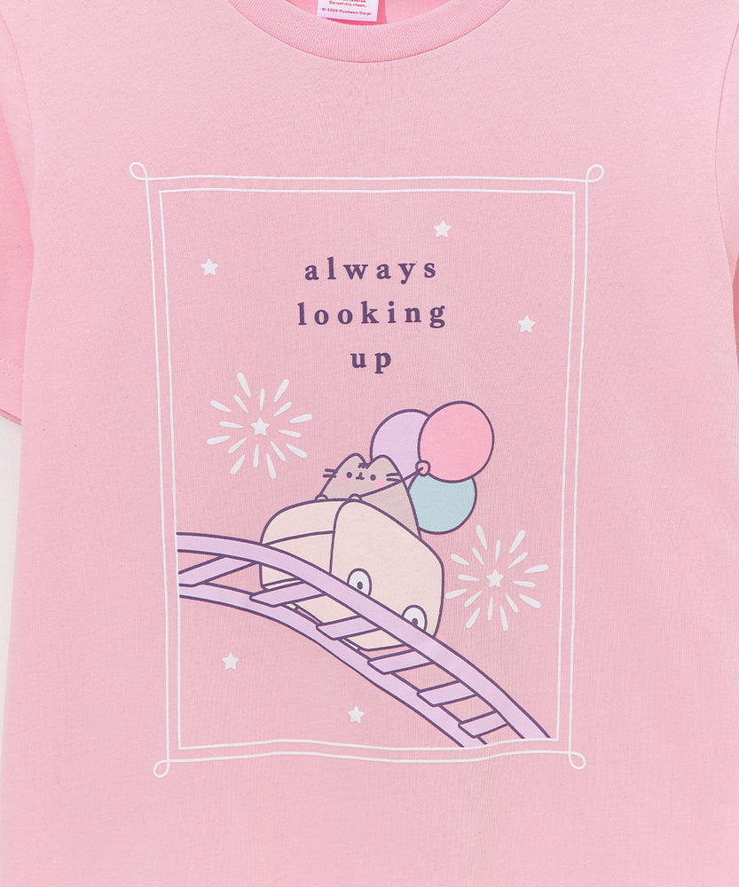 Light pink Pusheen tee hangs on a hanger. The fair-themed pink tee is apart of the Pusheen's 15th Anniversary collection.