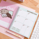 Pusheen Calendar page for the first week of December 2025. The left-hand page shows a Pusheen graphic with the right-hand page shows a 7-day calendar view.