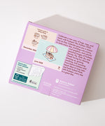 Back cover of the box containing the Pushee 2026 calendar. The back of the box lists the contents and the box and a brief product description. 