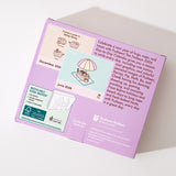 Back cover of the box containing the Pushee 2026 calendar. The back of the box lists the contents and the box and a brief product description. 