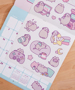 Back cover of the 2026 Pusheen Hanging Wall Calendar. The back covers shows a preview of all the art graphics inside the monthly calendar. 