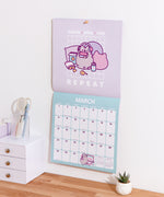 Wall-mounted calendar open to March 2026. The calendar portion includes an overview of the previous month and previews the next month in the bottom right hand corner.