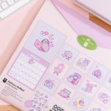 Back cover of the 2026 Pusheen Hanging Wall Calendar. The back covers shows a preview of all the art graphics inside the monthly calendar. 