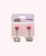Pusheen the Cat earrings attached to a pink and purple backer card. The grey cat has darker gray stripe details on the cat body while the balloons ties and Pusheen's eyes, mouth, and whiskers and the same silver as the outline.