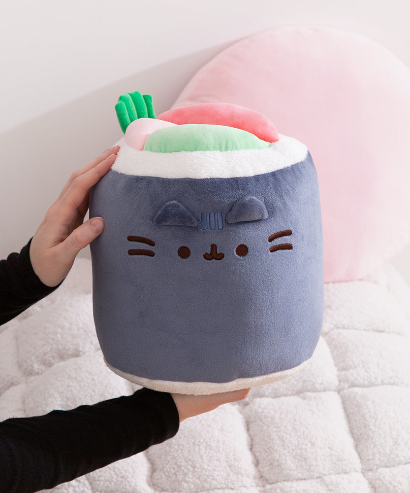 Model holding Pusheen Sushi Roll Plush to show size and scale of large plush toy.