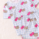 Cherry Pajama Set includes a light blue and white patterned short sleeve shirt with Pusheen graphics with pink cherries that match the pattern of the blue and white lounge shorts.  The shorts have side pockets and an elastic band top for a perfect fit.