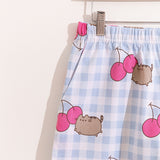 A close-up view of the Pusheen elastic band on the pajama shorts and one of the side pocket features of the shorts. 