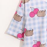 Close-up of drop-sleeve detail on the Cherry Pajama top. The print continues down the sleeve of the blue and white gingham pajama set.
