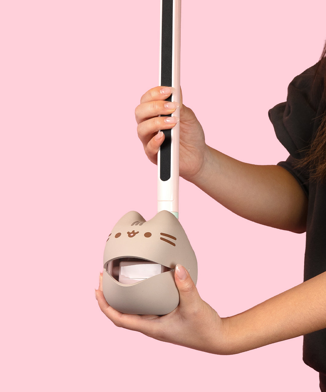 Close-up view of the musical mouth of the Pusheen Deluxe Otamatone. The gray body has Pusheen's gray head stripes as well as her brown whiskers, eyes, and mouth printed in a dark brown color on the front.