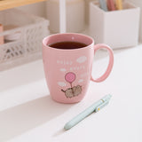 Enjoy Every Day Mug sits on a white desktop with tea inside the pink mug.