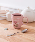 Enjoy Every Day Mug sits on a white desktop with tea inside the pink mug.