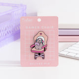 Gamer Deluxe Pin on its pink backer card. The card features a white grid pattern and says " Pusheen Shop" and "Gamer Chair Deluxe Pin."