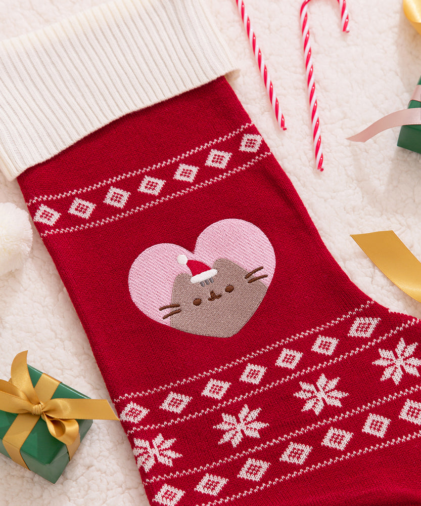 Close-up of the knit design details on the Pusheen stocking. A repeating pattern of white squares are shown at the top and bottom of the stocking.