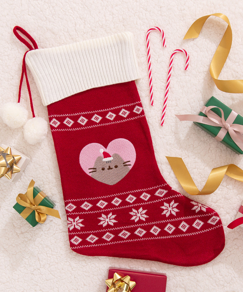 Front view of the red and white Pusheen Holiday Stocking. The red sock has a white ribbed top with a red hanging loop attached to the top.