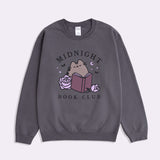 Gray sweatshirt with 'Midnight Book Club' design featuring Pusheen the Cat reading a book surrounded by roses, bats, stars, and a crescent moon.