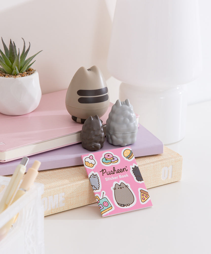 Back view of the Pusheen Nesting Dolls set. Pusheen's doll features her two classic back stripes and striped tail.