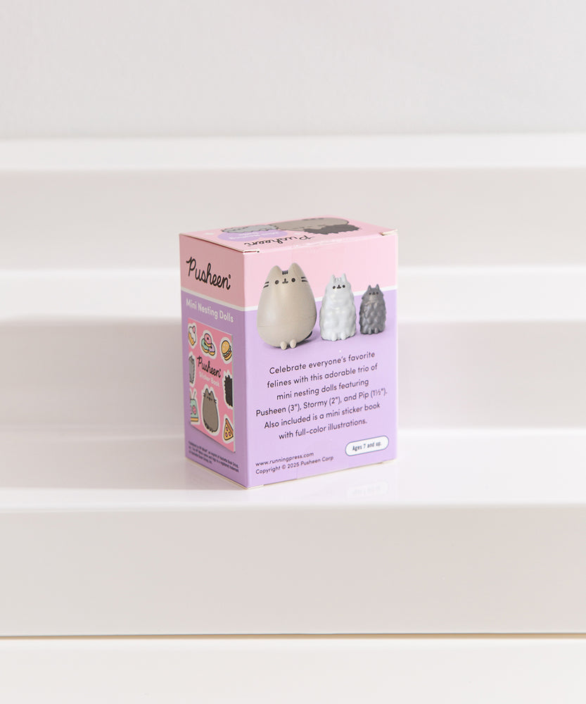Back view of the Pusheen Mini Nesting Dolls purple and pink packaging. The text on the back details the contents of the box.