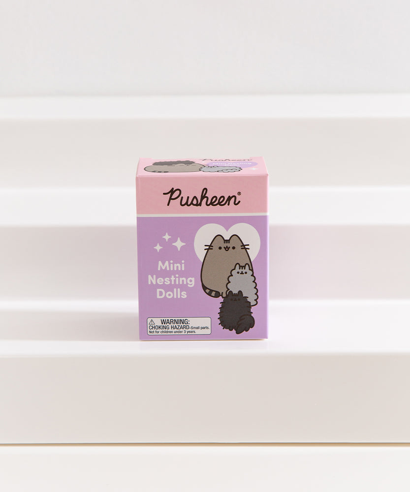 Front view of the Pusheen Mini Nesting Dolls packaging on a white shelf.