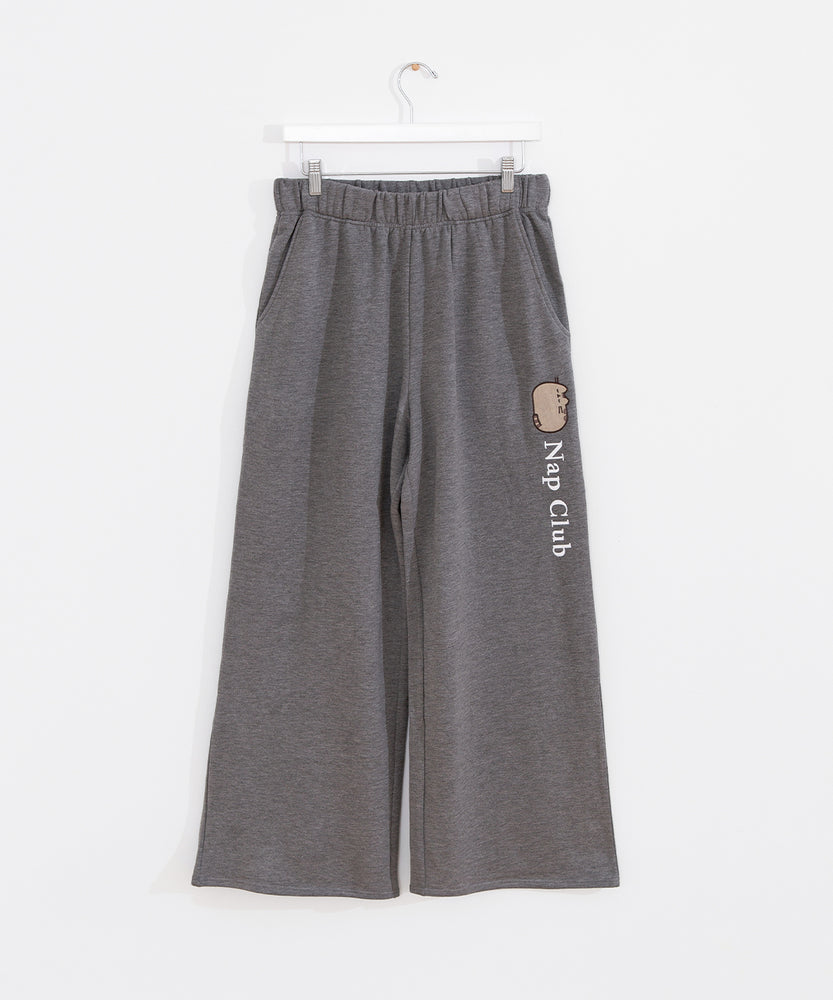 Gray sweatpants hanging on a white bottoms hanger to show full silhouette of wide-leg pant.