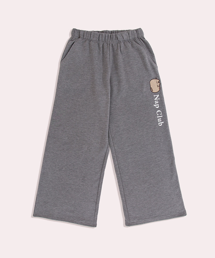 Front view of the Loungewear pants. Going down the wearer's left side is the phrase "Nap Club" with a sleeping Pusheen graphic. The joggers feature a stretch waistband and side pockets.