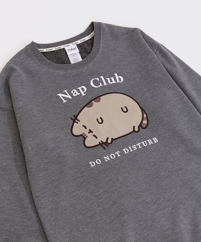 Gray sweatshirt with a sleeping grey cat. Surrounding the cat is the text "Nap Club" and "Do Not Disturb"