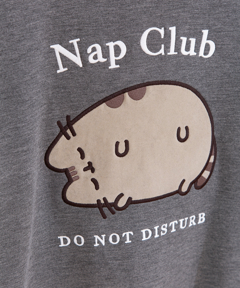 Close-upf of flocked treatment on the Nap Club Pusheen Sweatshirt. The gray cat is shown with brown details and outlined in black.