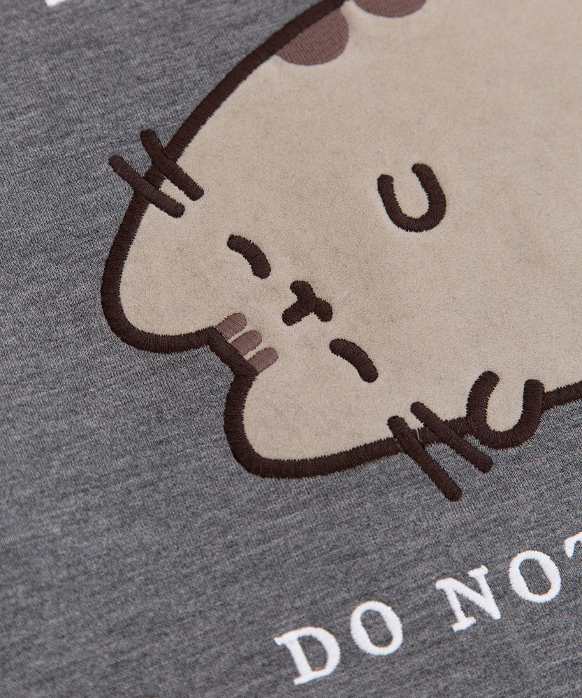 Close-up of the flocked material on the Sweatshirt. The gray cat is flocked while her details are embroidered.