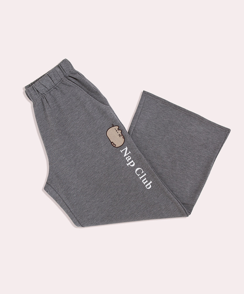 Gray sweatpants with "Nap Club" embroidery text going down one leg of the pants below the side pocket.