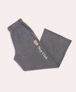 Gray sweatpants with "Nap Club" embroidery text going down one leg of the pants below the side pocket.