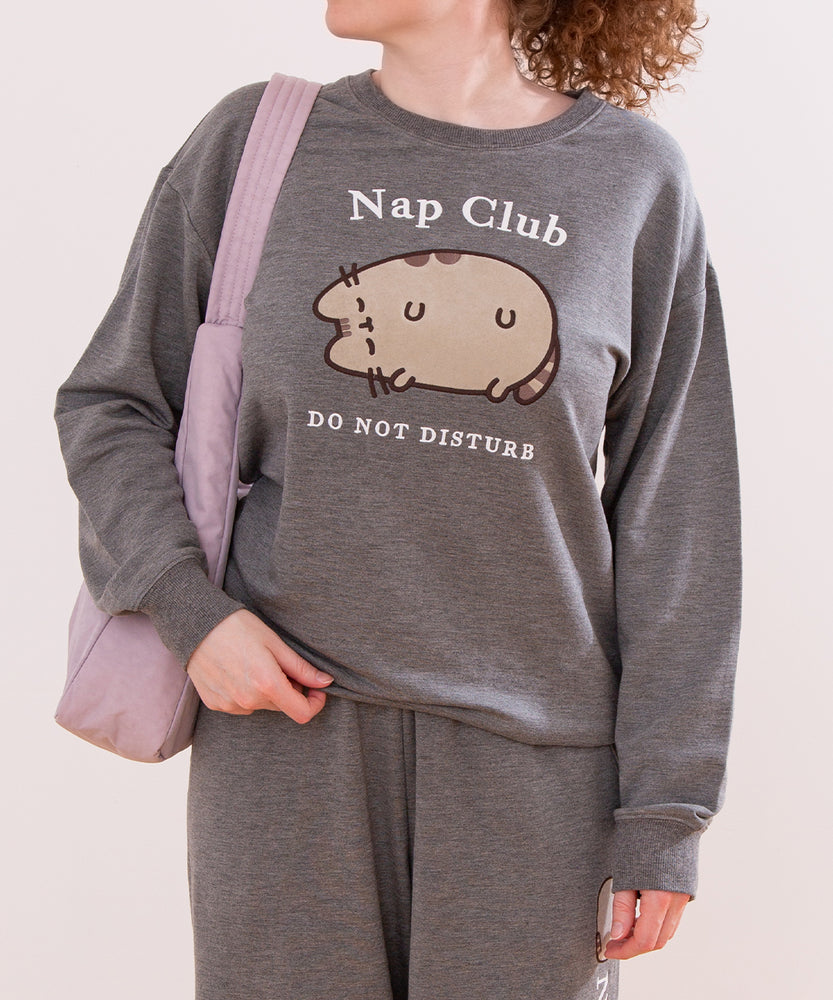 Model wearing heather gray Nap Club Sweatshirt with a large front graphic that's flocked and embroidered.