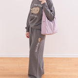 Modeal wearing a gray Pusheen Nap Club Loungewear Set. The matching set includes a sweatshirt and a wide-leg sweat pant.