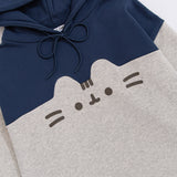 Front view of the Pusheen Navy Relaxed-Fit Character Hoodie lying on a white surface. The two-toned sweatshirt has a navy blue hoodie and chest coloring while the sleeves and bottom of the sweatshirt are light heather gray. 