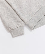 A close-up view of the cuff and hem of the Pusheen Sweatshirt. The light gray sweatshirt has tapered, ribbed detailing on the cuff and hem of the hoodie. 