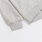A close-up view of the cuff and hem of the Pusheen Sweatshirt. The light gray sweatshirt has tapered, ribbed detailing on the cuff and hem of the hoodie. 