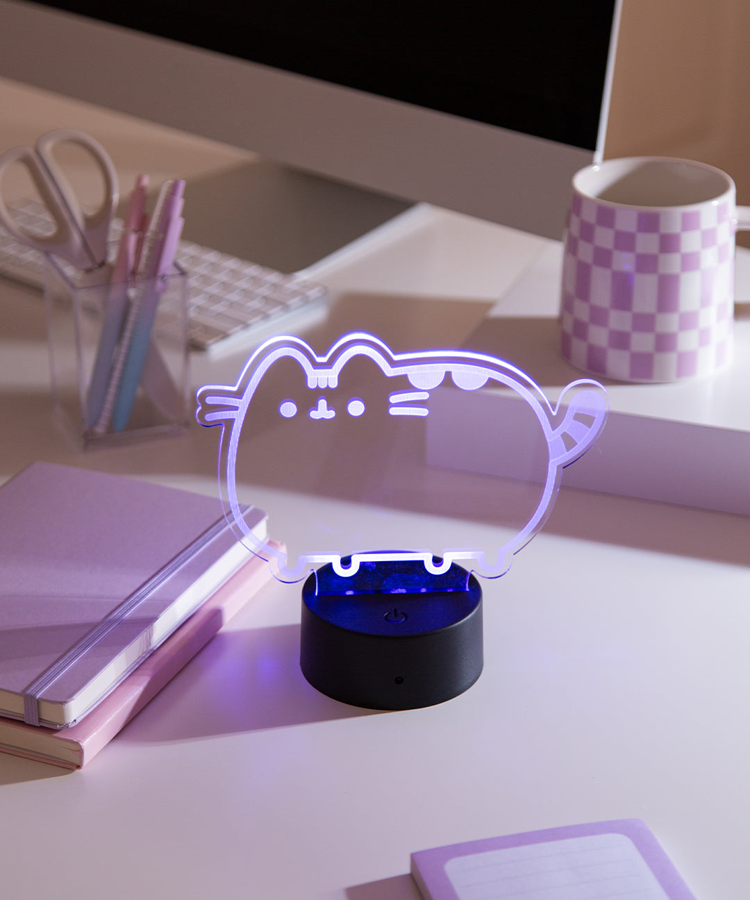 Pusheen Otaku Lamp on a desktop. The acrylic lamp is shown in a purple color.
