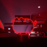 Red neon cat-shaped light on a dark background.