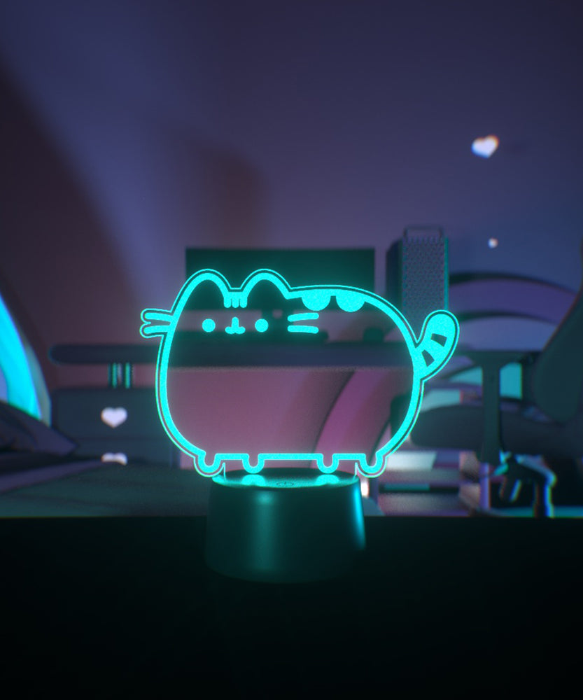 Teal neon light shaped like a cat on a desktop.