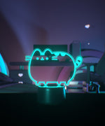Teal neon light shaped like a cat on a desktop.