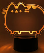 Close-up of the acrylic plate on the Pusheen Otaku Lamp. The lamp is set to the color orange.