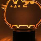Close-up of the acrylic plate on the Pusheen Otaku Lamp. The lamp is set to the color orange.