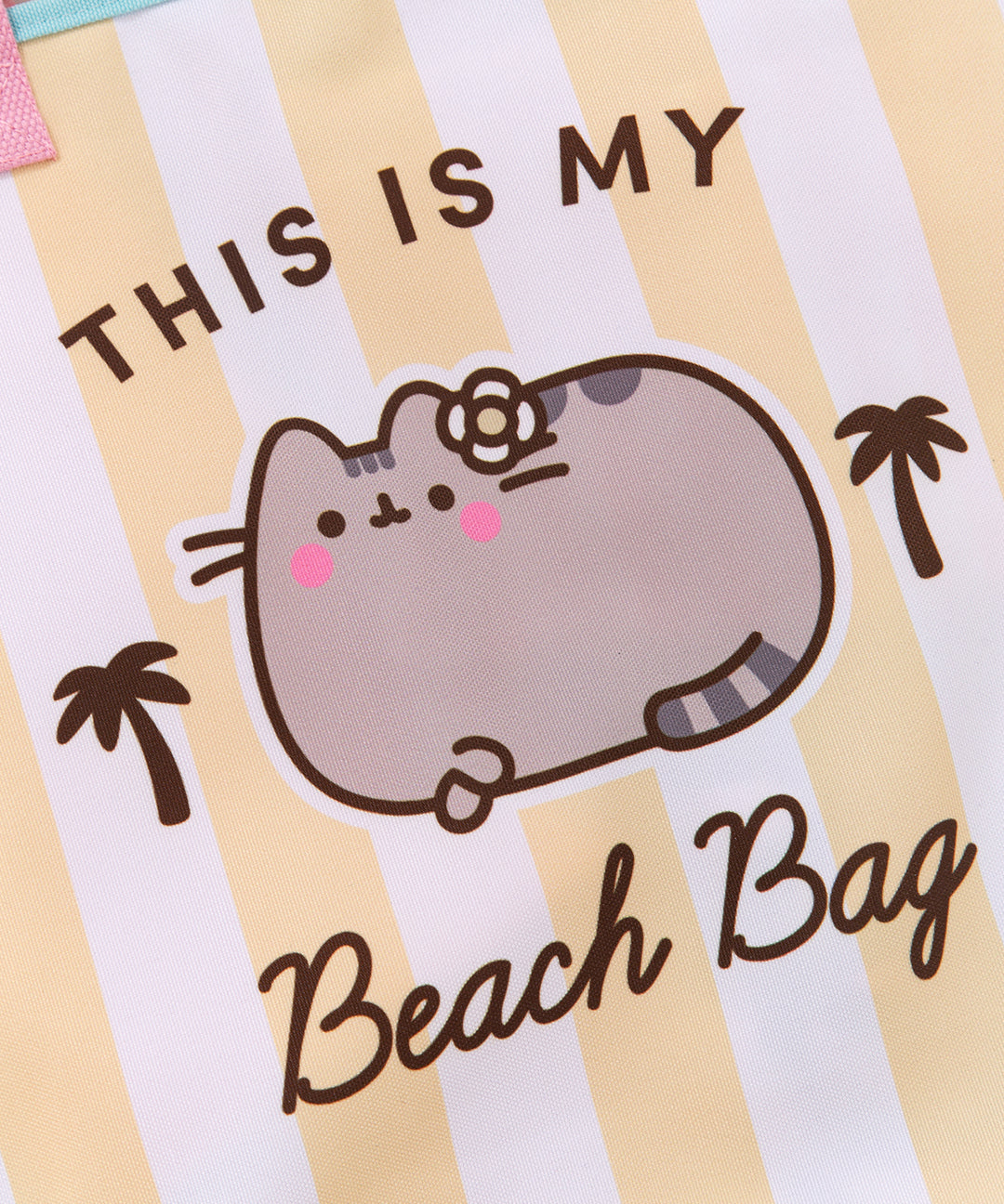 Close-up of the Pusheen graphic on the extra large tote bag. The background of the graphic is white and yellow vertical stripes. The front center graphic shows Pusheen blushing with a flower tucked next to her ear.
